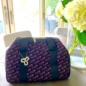 TNA small duffel bag with pink writing